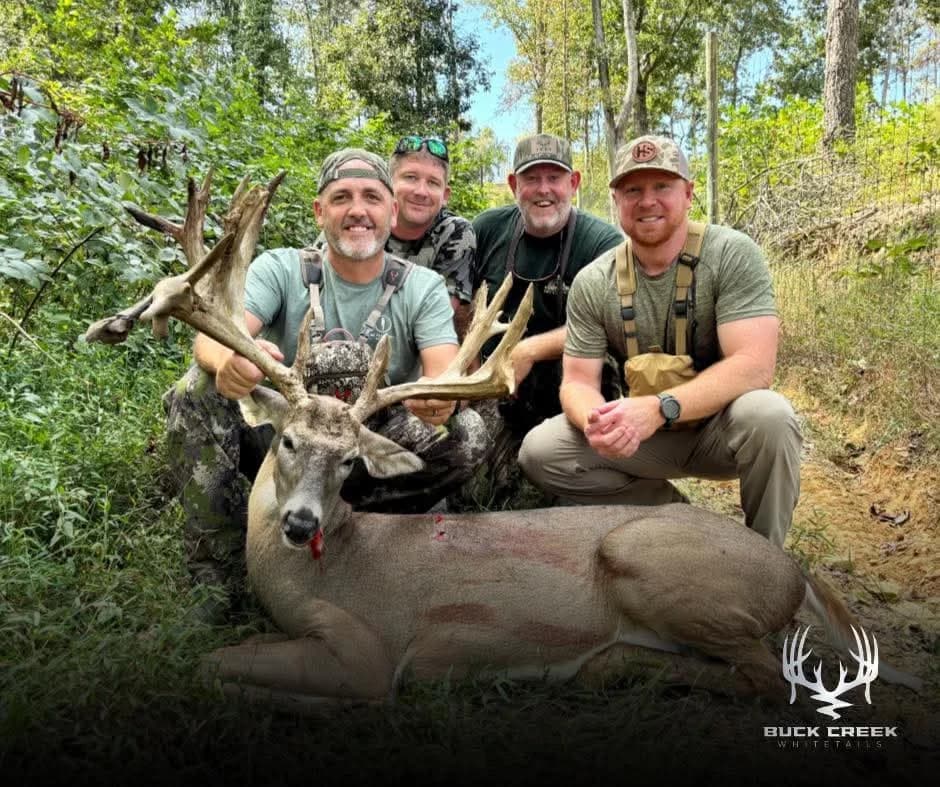 Four hunters together with a trophy whitetail at Buck Creek